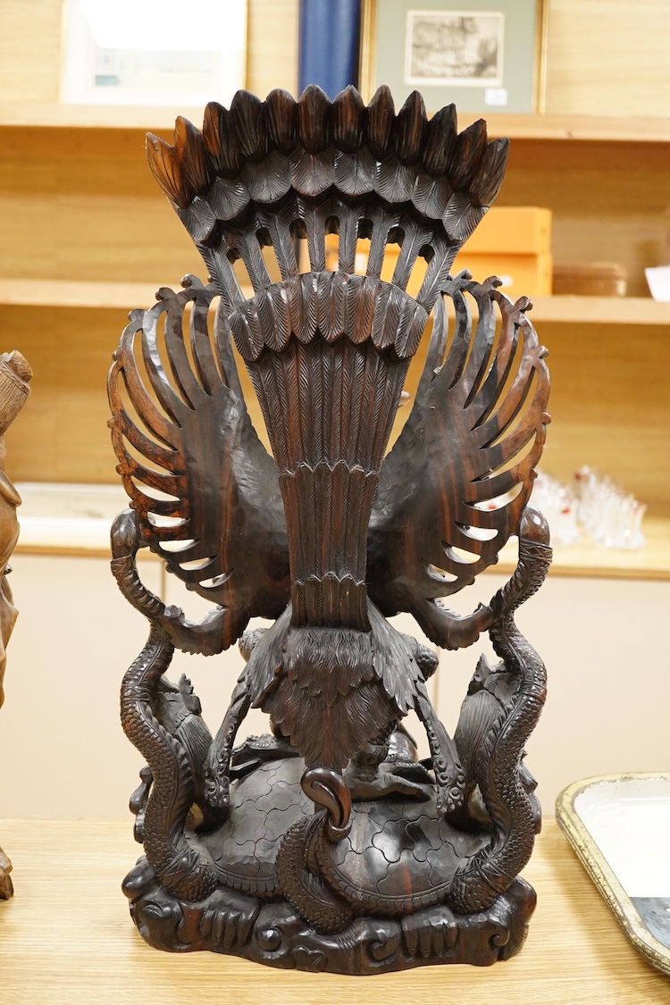 A large Indonesian hardwood Garuda group and a Chinese hardwood figure of a Luohan, largest 61cm high